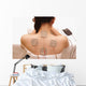 Asian woman is doing massage of electrical -stimulation ( TENs ) Wall Mural