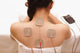 Asian woman is doing massage of electrical -stimulation ( TENs ) Wall Mural