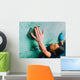 Woman climbing up on wall in gym Wall Mural