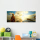 Woman a backpack looking at the sunset. Wall Mural
