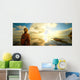 Woman a backpack looking at the sunset. Wall Mural