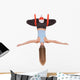 Young woman doing aerial yoga in hammock on a Wall Decal