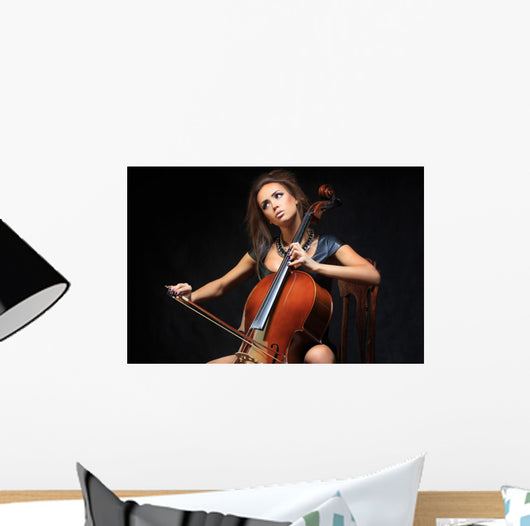 beautiful female musician playing a cello. Wall Mural