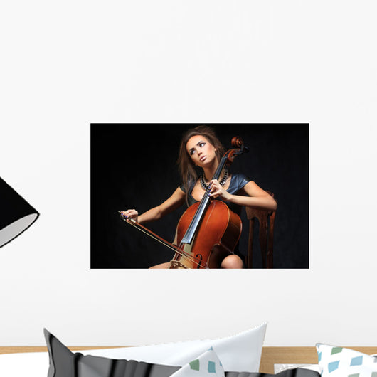 beautiful female musician playing a cello. Wall Mural