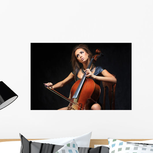 beautiful female musician playing a cello. Wall Mural