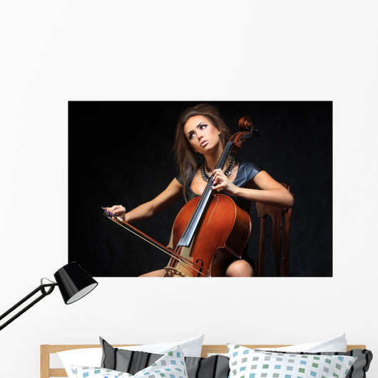 beautiful female musician playing a cello. Wall Mural