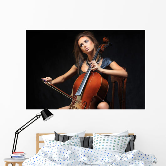 beautiful female musician playing a cello. Wall Mural