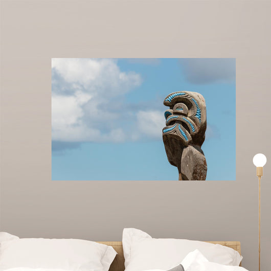Maori totem against blue sky Wall Mural