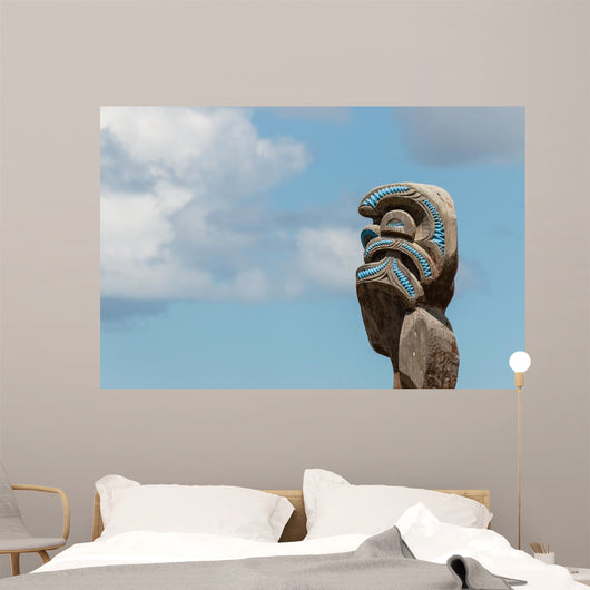 Maori totem against blue sky Wall Mural