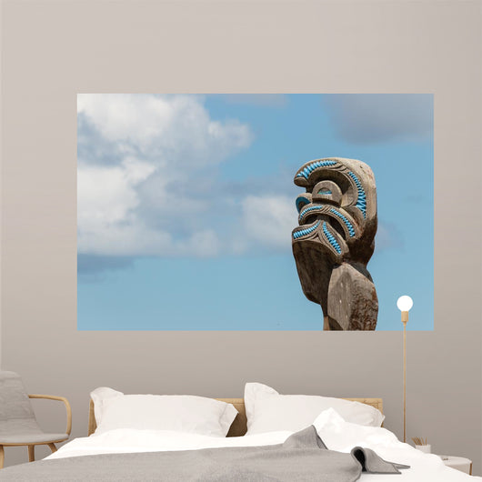 Maori totem against blue sky Wall Mural