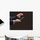 Concert conductor's hands with a baton, isolated on a black Wall Mural