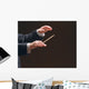 Concert conductor's hands with a baton, isolated on a black Wall Mural