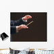 Concert conductor's hands with a baton, isolated on a black Wall Mural