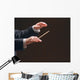 Concert conductor's hands with a baton, isolated on a black Wall Mural