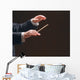 Concert conductor's hands with a baton, isolated on a black Wall Mural