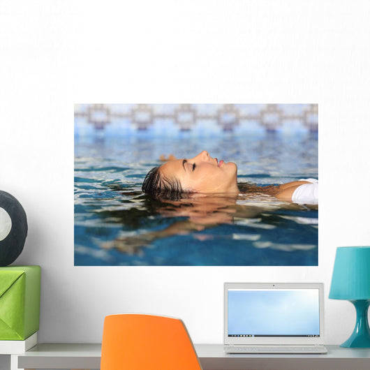 Profile of a beauty relaxed woman face floating in water Wall Mural