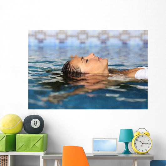 Profile of a beauty relaxed woman face floating in water Wall Mural