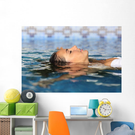 Profile of a beauty relaxed woman face floating in water Wall Mural