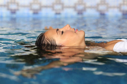 Profile of a beauty relaxed woman face floating in water Wall Mural