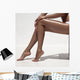 Beautiful woman tan legs. Against white wall. Wall Mural