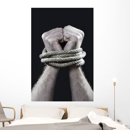 white man hands wrapped rope around wrists victim abused concept Wall Mural