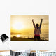 Successful sporty woman with arms up Wall Mural