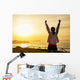 Successful sporty woman with arms up Wall Mural