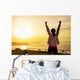 Successful sporty woman with arms up Wall Mural