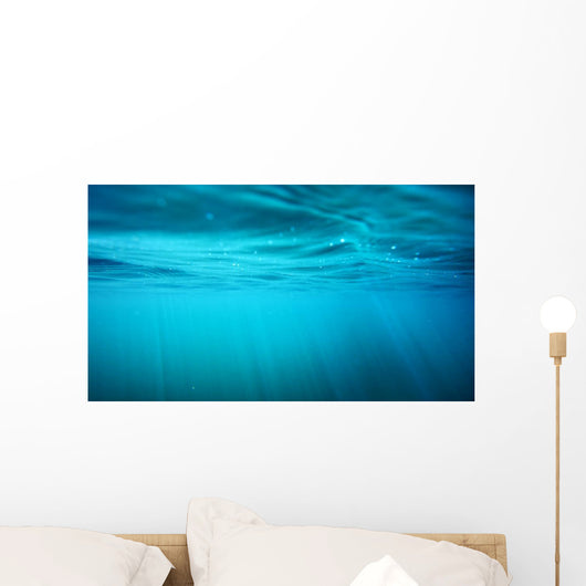 Underwater view with sun beams in turquoise water Wall Mural