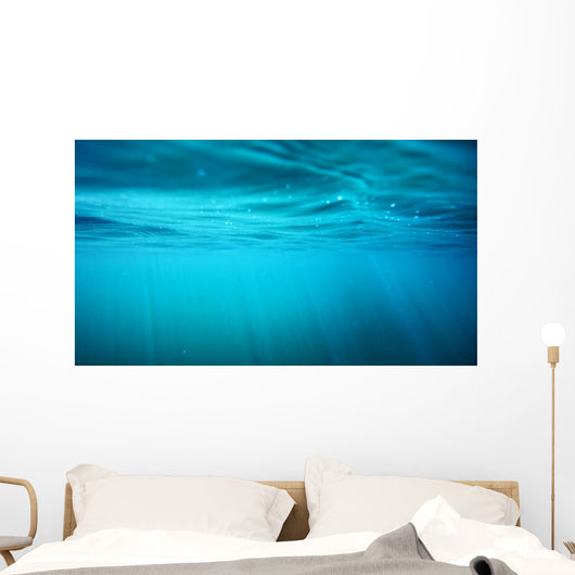 Underwater view with sun beams in turquoise water Wall Mural