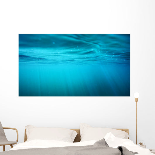 Underwater view with sun beams in turquoise water Wall Mural