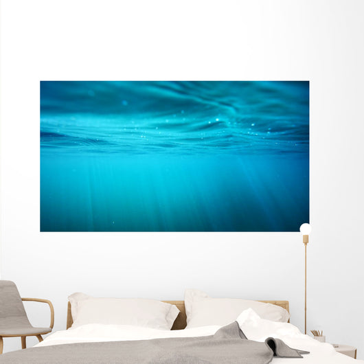 Underwater view with sun beams in turquoise water Wall Mural