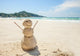 snowman made of sand on a background of the tropical warm sea Wall Mural