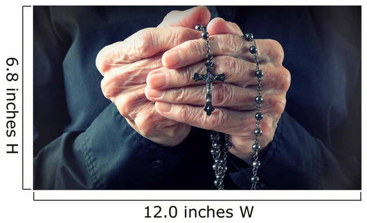 Hands of an elder woman holding a rosary while praying Wall Mural