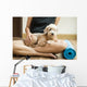 woman holding dog in yoga class Wall Mural