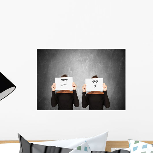 two women hiding behind sheets of paper Wall Mural