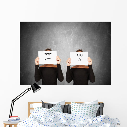 two women hiding behind sheets of paper Wall Mural