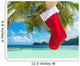 Christmas sock on palm tree at exotic tropical beach Wall Mural