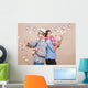 Young couple in a Photo Booth party with gesture face Wall Mural