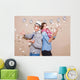 Young couple in a Photo Booth party with gesture face Wall Mural