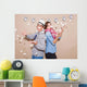 Young couple in a Photo Booth party with gesture face Wall Mural
