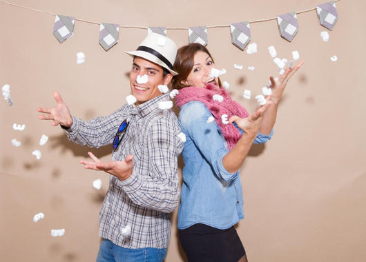 Young couple in a Photo Booth party with gesture face Wall Mural