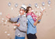 Young couple in a Photo Booth party with gesture face Wall Mural