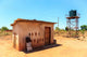 House with water tank in a village in Africa Wall Mural