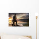 Young man fishing at misty sunrise Wall Mural