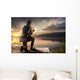 Young man fishing at misty sunrise Wall Mural
