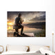 Young man fishing at misty sunrise Wall Mural