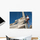 young man working on mast of sailing ship Wall Mural