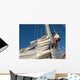 young man working on mast of sailing ship Wall Mural