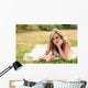 Romantic girl writing in a diary lying down outdoors Wall Mural